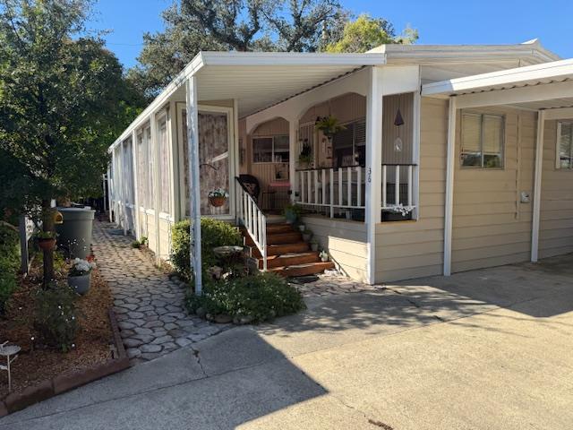 a view of a house with backyard and porch