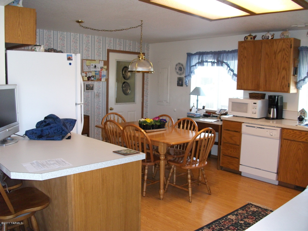 2350 Duffield Road Moxee, WA 98936 - Photo 13 of 21 a kitchen with stainless steel appliances a table chairs and a refrigerator
