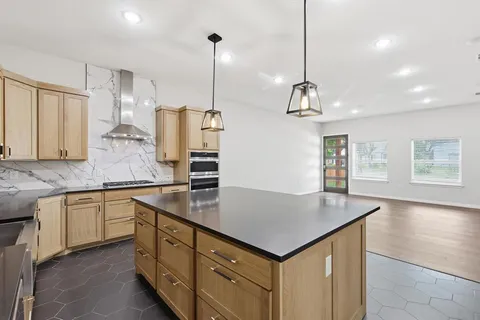 a kitchen with a sink center island and stainless steel appliances