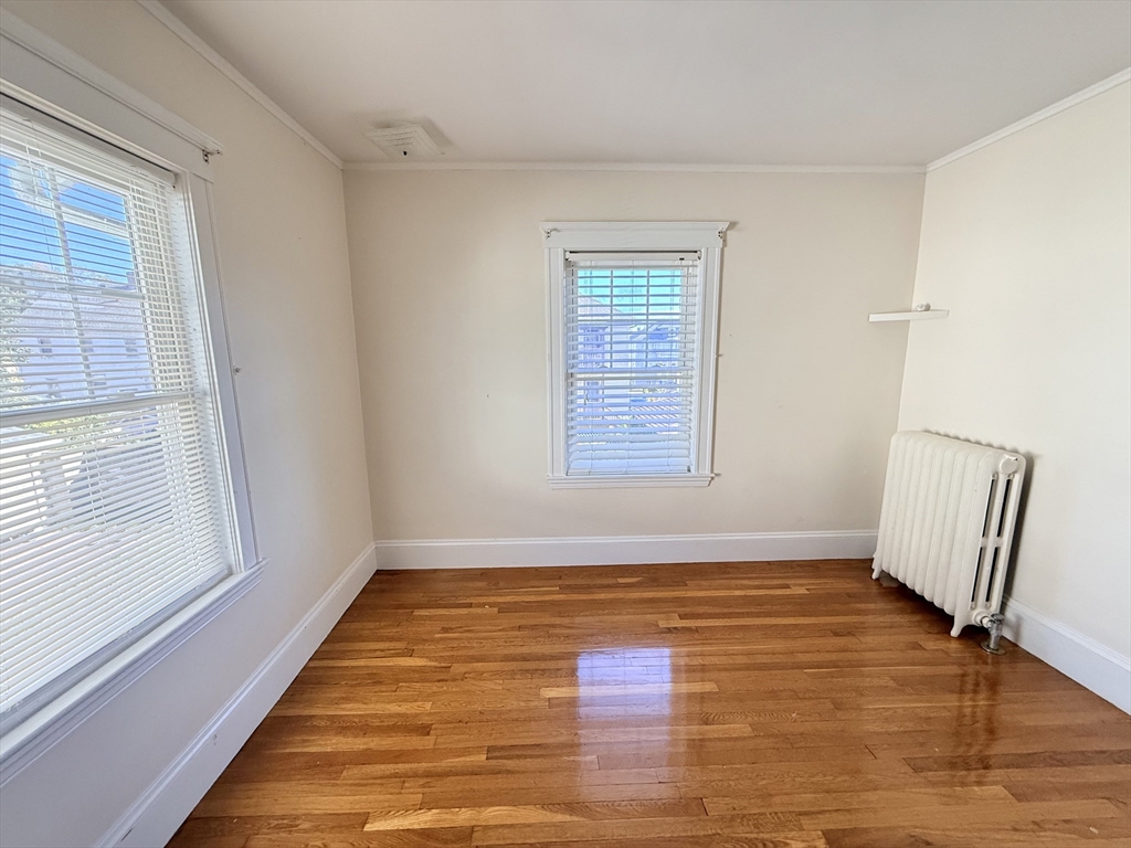 48 Rosewood Street, Unit 2 Boston, MA 02126 - Photo 12 of 26 a view of an empty room with window and wooden floor