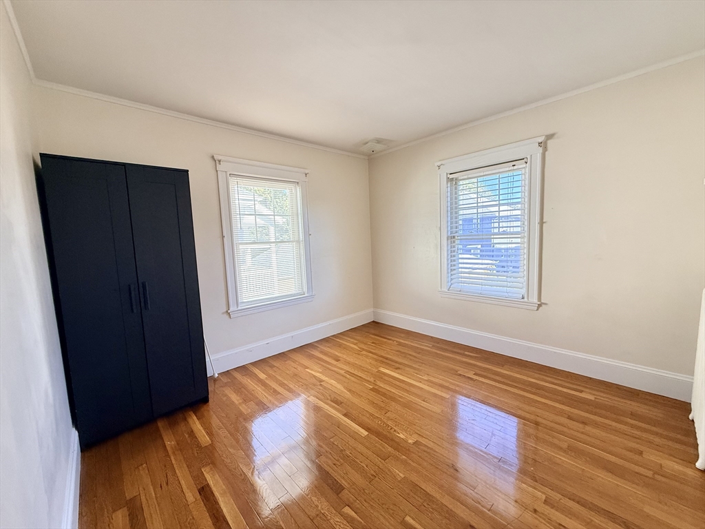 48 Rosewood Street, Unit 2 Boston, MA 02126 - Photo 13 of 26 a view of an empty room with wooden floor and a window