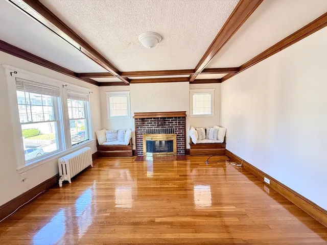 a living room with a fireplace furniture and a large window