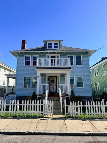 a view of a brick house with many windows