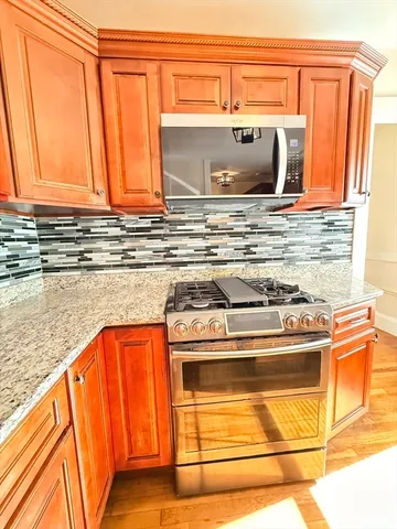 a bathroom with granite countertop a sink and a stove
