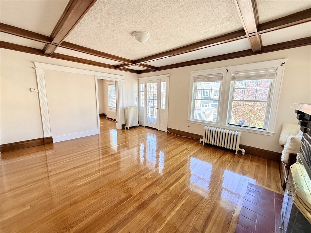 48 Rosewood Street, Unit 2 Boston, MA 02126 - Photo 10 of 26 a view of an empty room with wooden floor and a window