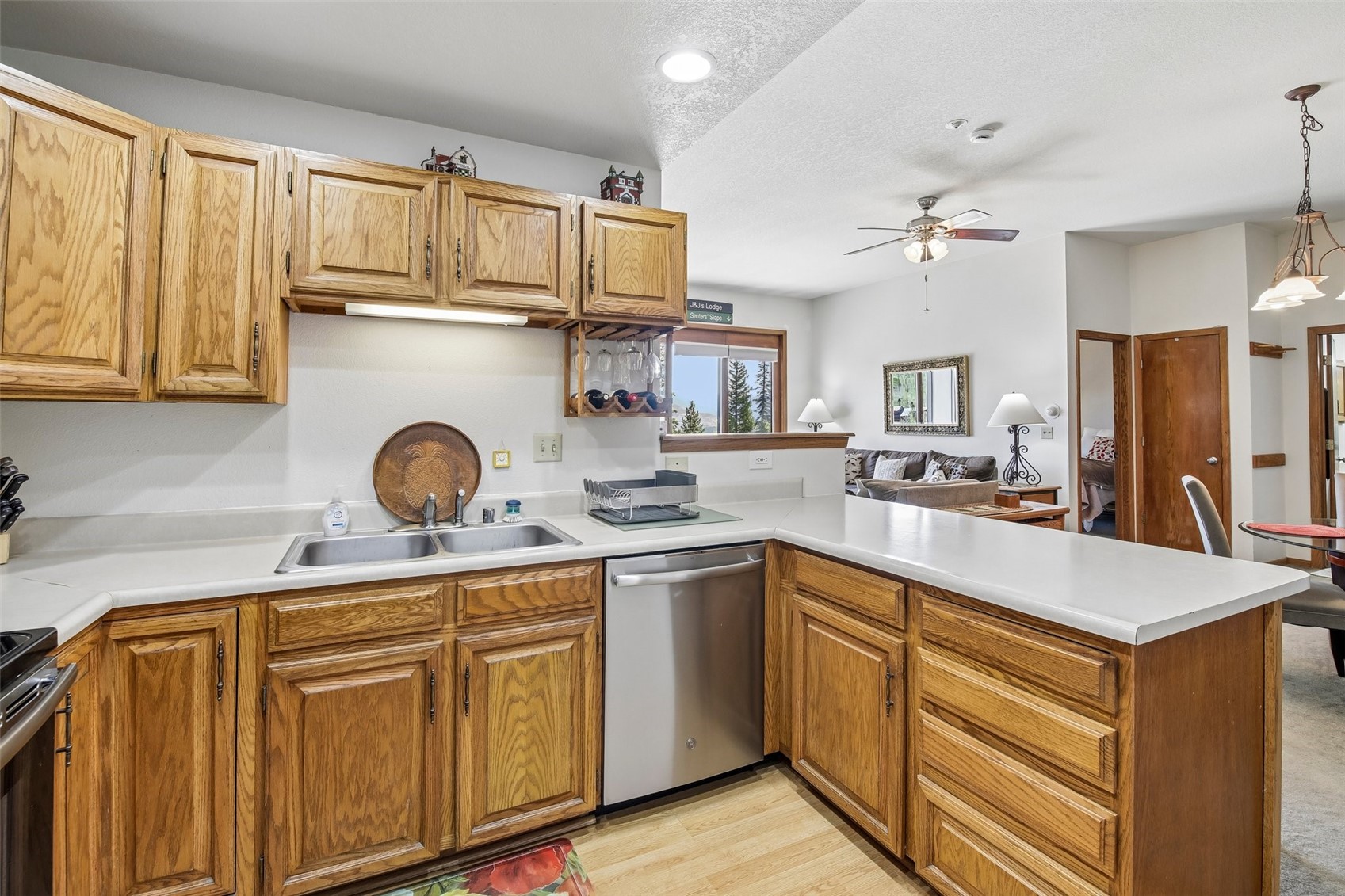 89310 Ryan Gulch Road, Unit 103 Silverthorne, CO 80498 - Photo 9 of 48 a kitchen with cabinets a sink and appliances