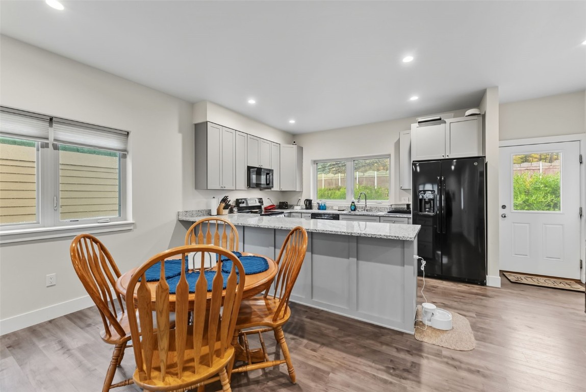83 Ermine Road, Unit 3A Dillon, CO 80435 - Photo 5 of 33 a kitchen with stainless steel appliances granite countertop a dining table chairs refrigerator sink and cabinets
