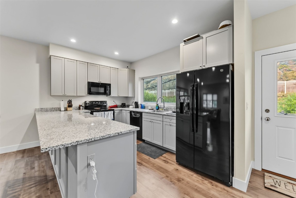 83 Ermine Road, Unit 3A Dillon, CO 80435 - Photo 8 of 33 a kitchen with kitchen island granite countertop appliances cabinets a sink and a counter top space