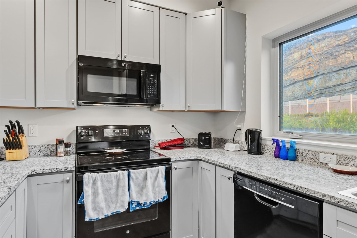 83 Ermine Road, Unit 3A Dillon, CO 80435 - Photo 10 of 33 a kitchen with stainless steel appliances granite countertop a sink stove and microwave