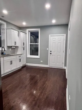 a view of a kitchen with a sink and dishwasher wooden floor