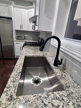 a kitchen with a sink a stove and refrigerator