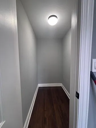 a view of hallway with wooden floor