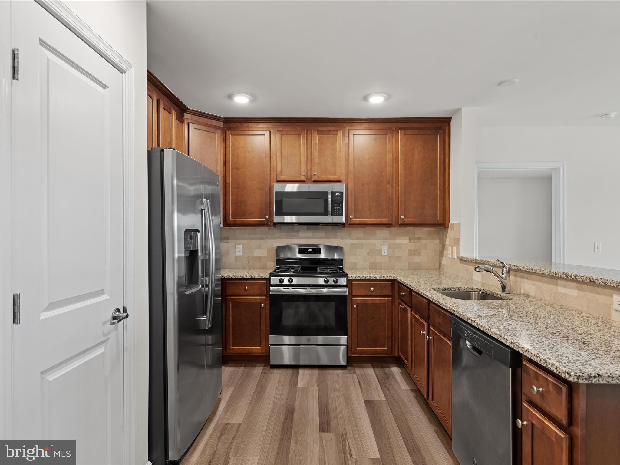 24258 Zinfandel Lane, Unit R303 Lewes, DE 19958 - Photo 14 of 82 a kitchen with a sink stove and refrigerator