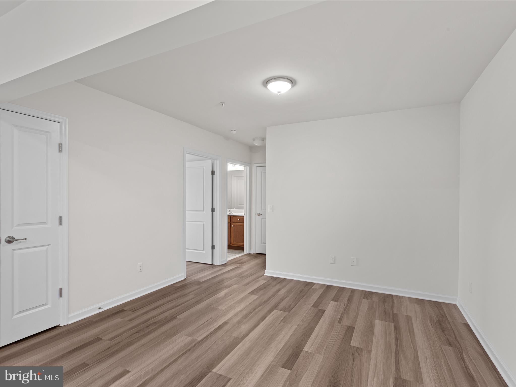 24258 Zinfandel Lane, Unit R303 Lewes, DE 19958 - Photo 18 of 82 a view of an empty room with wooden floor