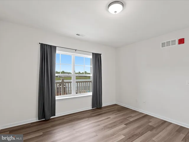 a view of a kitchen with stainless steel appliances granite countertop a stove a sink and a microwave