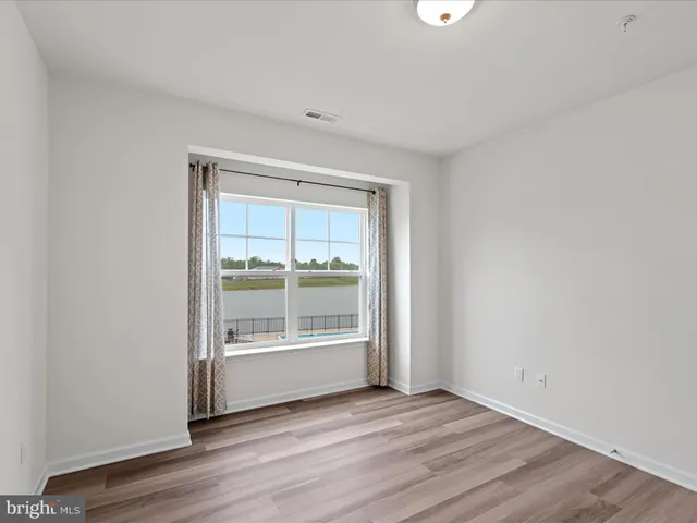 a view of a kitchen with wooden floor and a sink