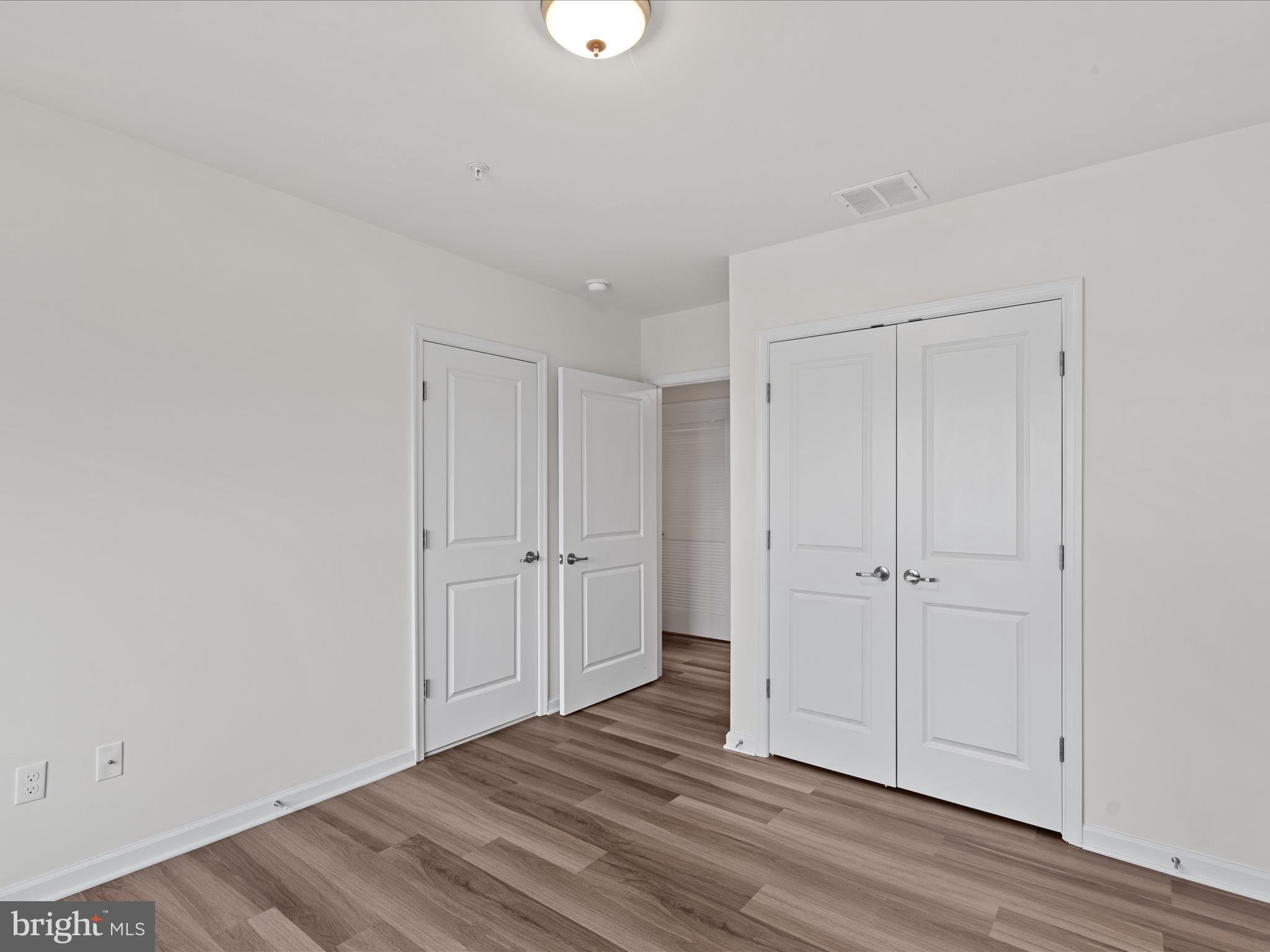 24258 Zinfandel Lane, Unit R303 Lewes, DE 19958 - Photo 28 of 82 a view of empty room with wooden floor