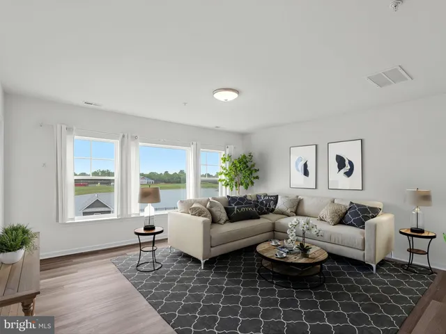a living room with furniture kitchen view and a table