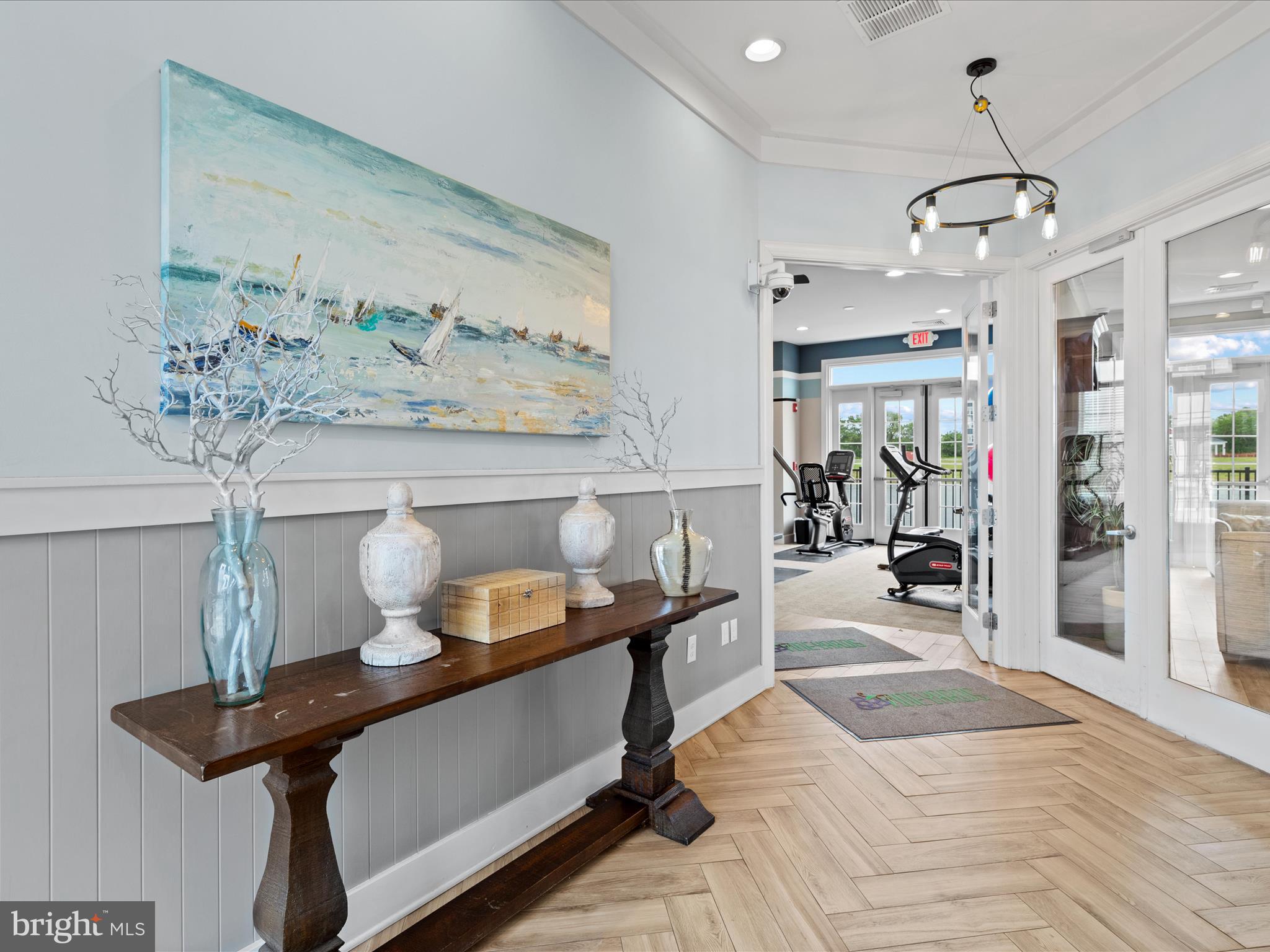 24258 Zinfandel Lane, Unit R303 Lewes, DE 19958 - Photo 48 of 82 a living room with furniture and a chandelier