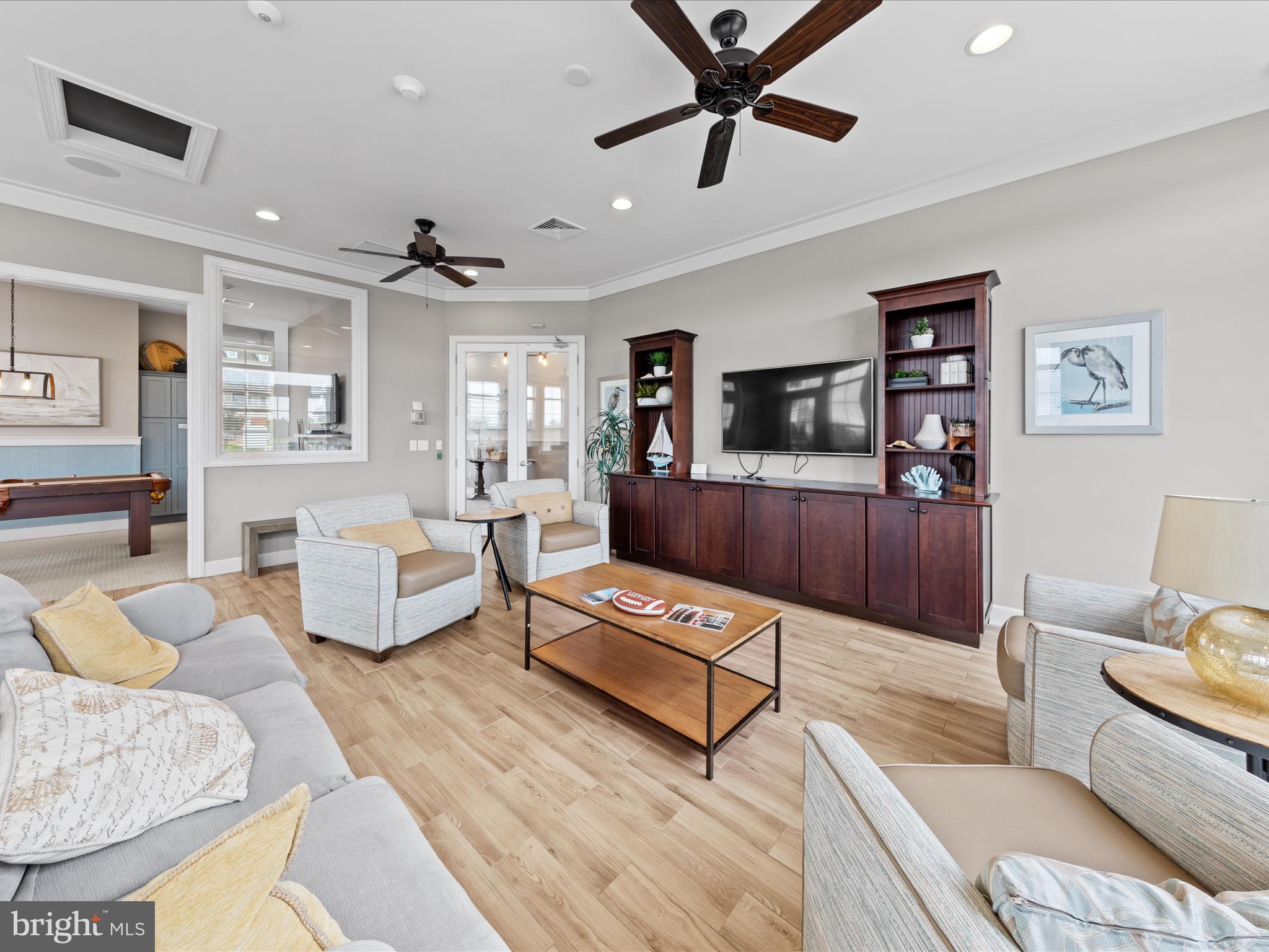 24258 Zinfandel Lane, Unit R303 Lewes, DE 19958 - Photo 55 of 82 a living room with furniture and a flat screen tv