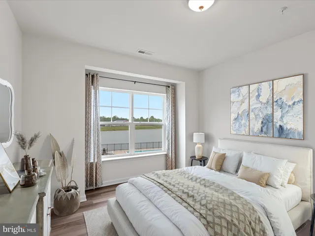 a bedroom with a bed and glass window