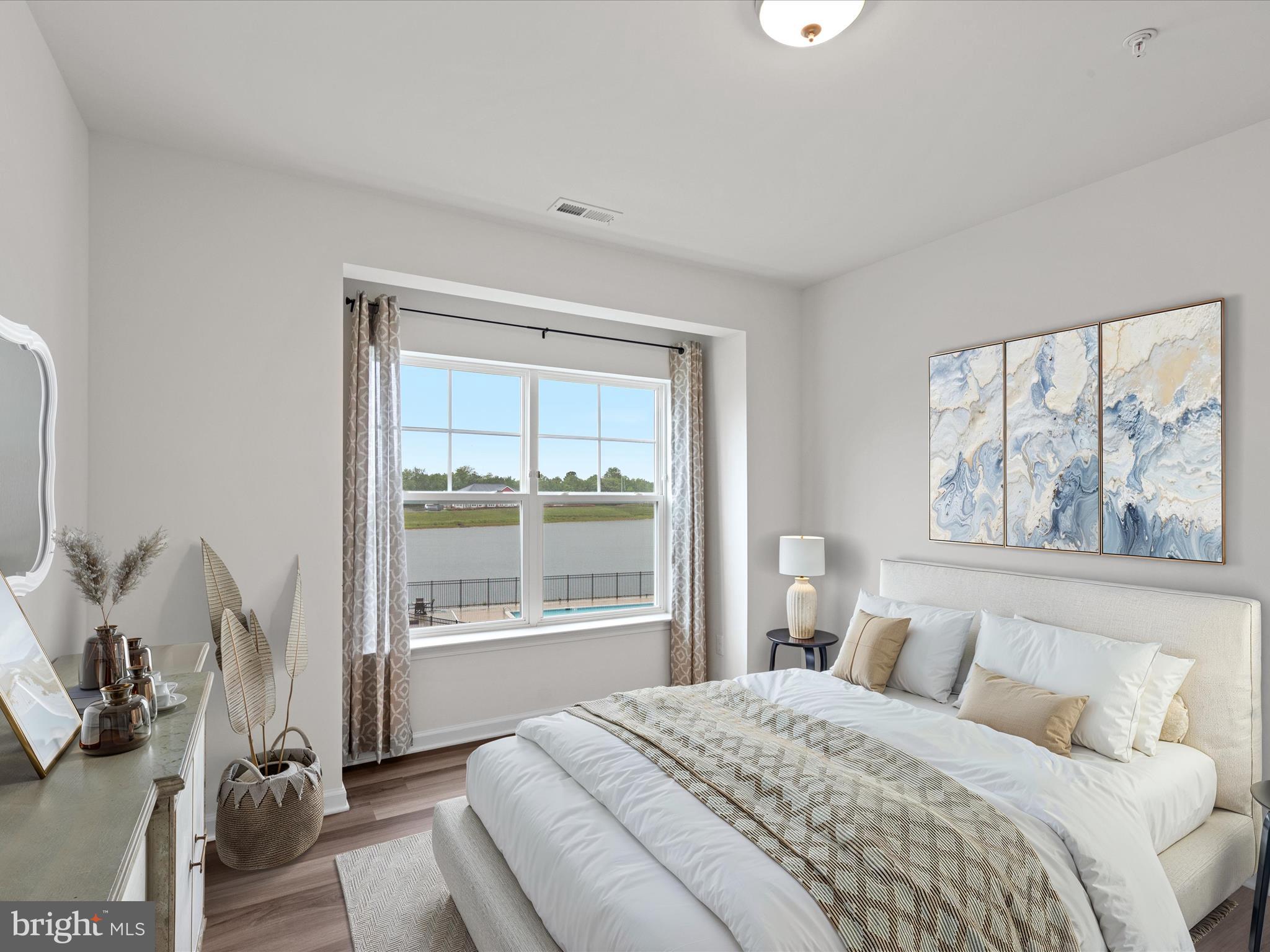 24258 Zinfandel Lane, Unit R303 Lewes, DE 19958 - Photo 6 of 82 a bedroom with a bed and a large window