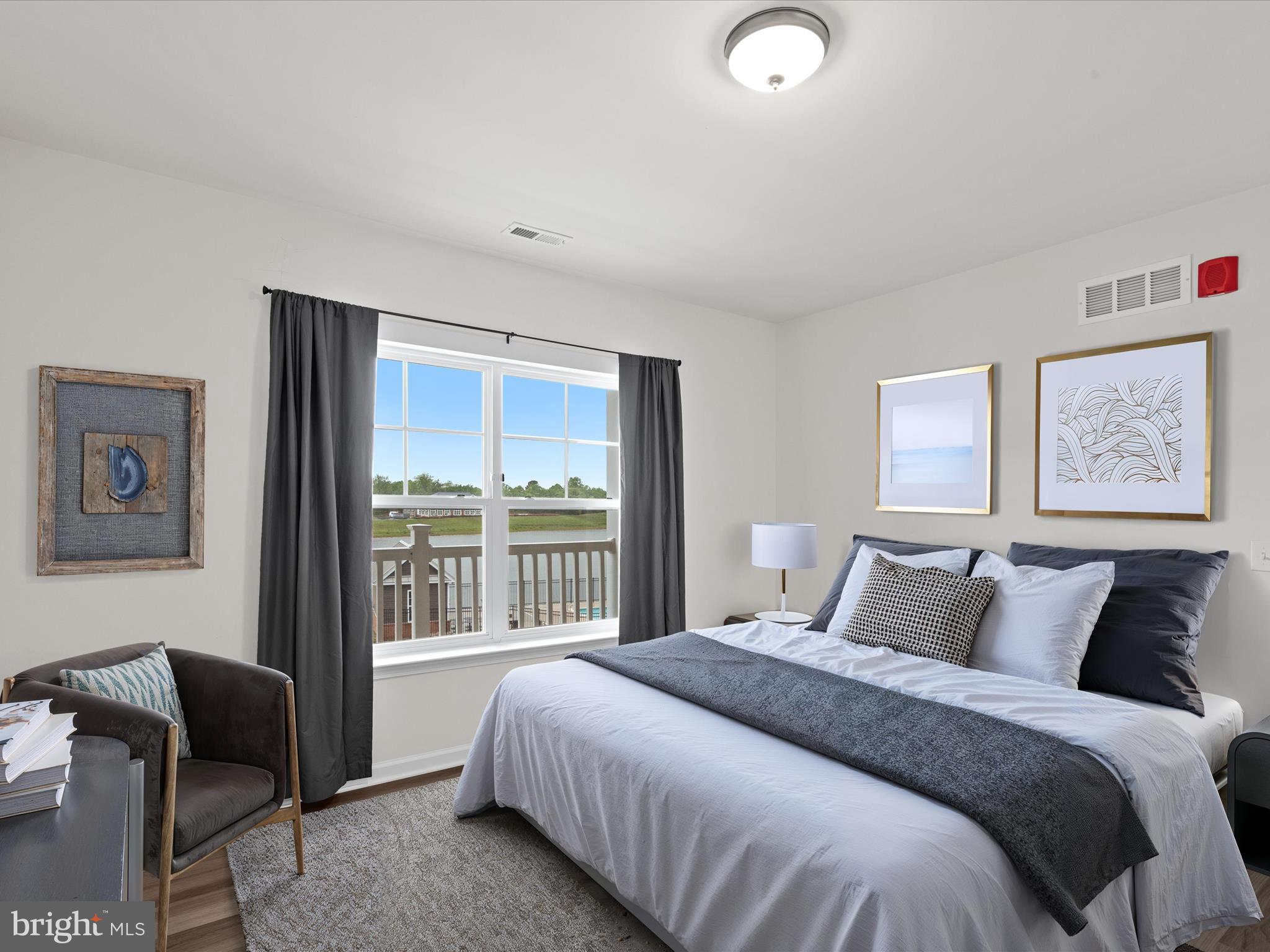 24258 Zinfandel Lane, Unit R303 Lewes, DE 19958 - Photo 7 of 82 a bedroom with a bed and glass window