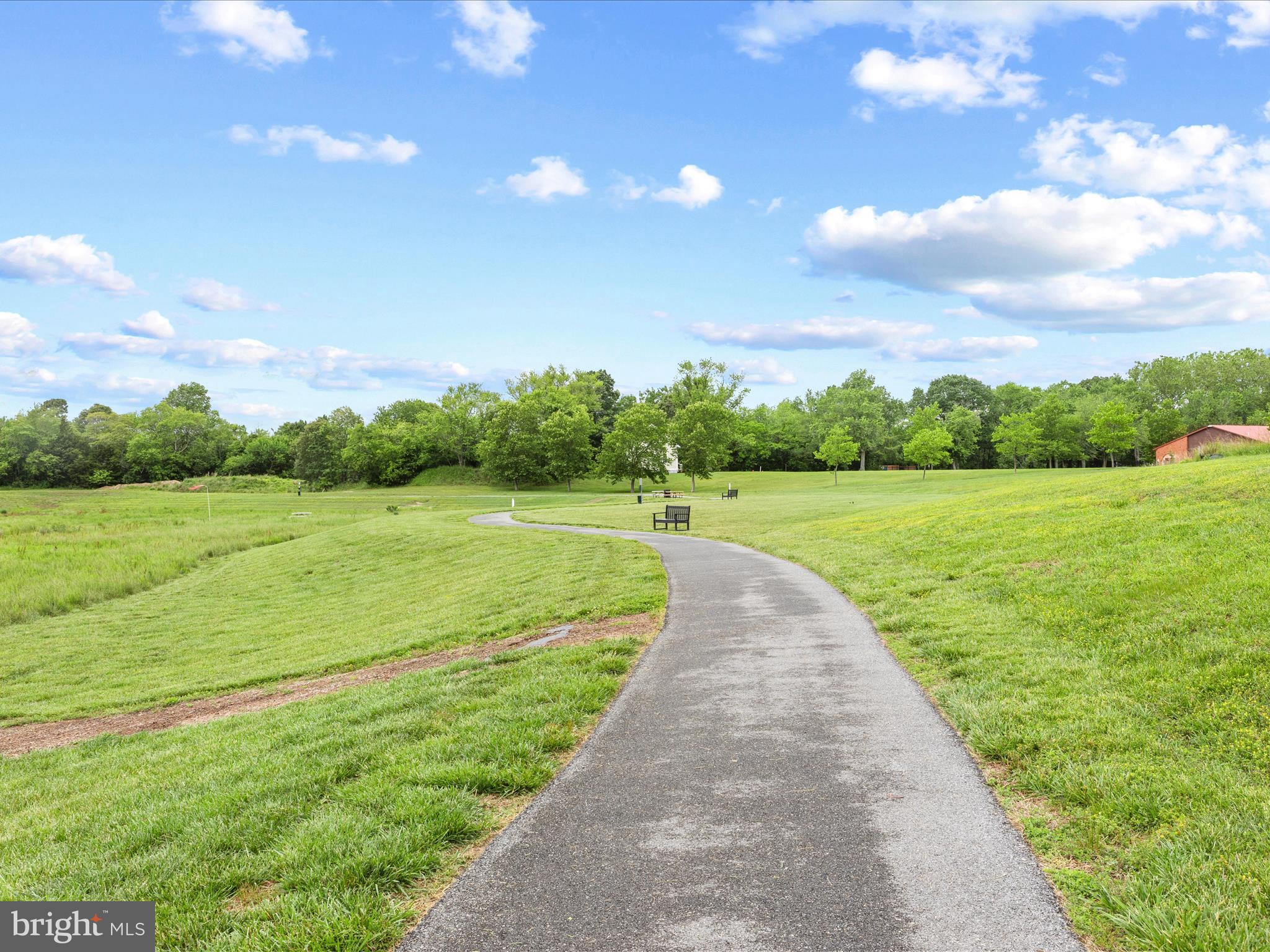 24258 Zinfandel Lane, Unit R303 Lewes, DE 19958 - Photo 71 of 82 a view of a grassy field with an trees