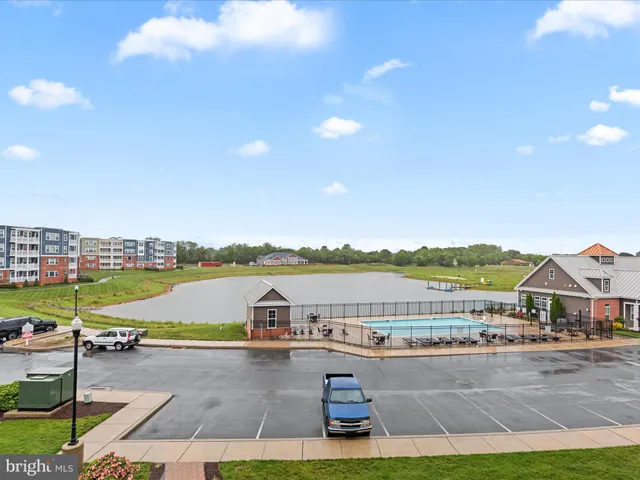 a kitchen with stainless steel appliances granite countertop a refrigerator a stove top oven a sink and dishwasher