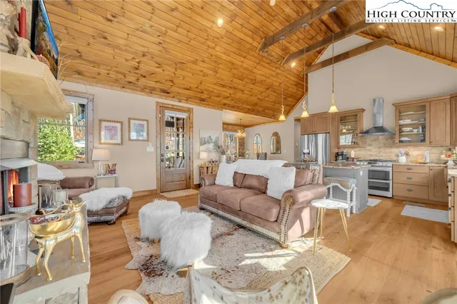 a living room with fireplace furniture and a wooden floor