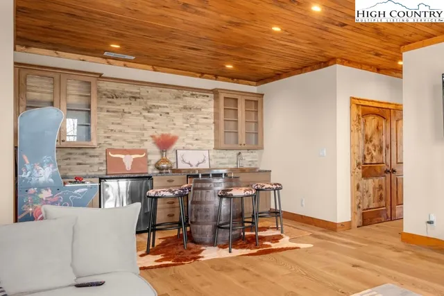 a room with pool table and windows