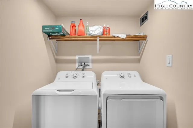 a bed sitting in a spacious bedroom next to a window