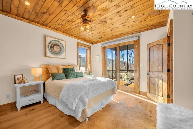 a bedroom with a large bed and a chandelier