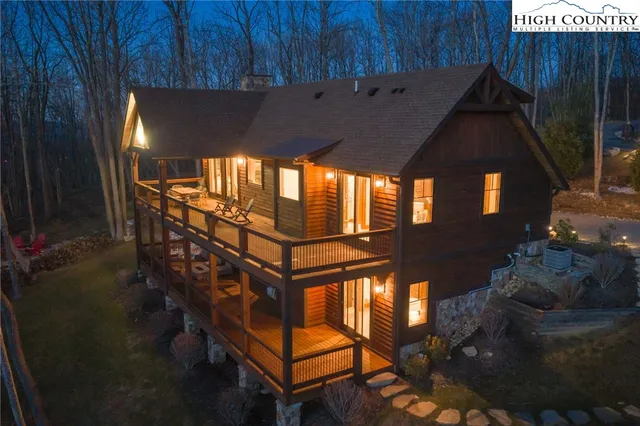 a view of a chairs and table in the backyard