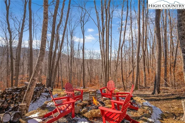 a view of a backyard with wooden fence