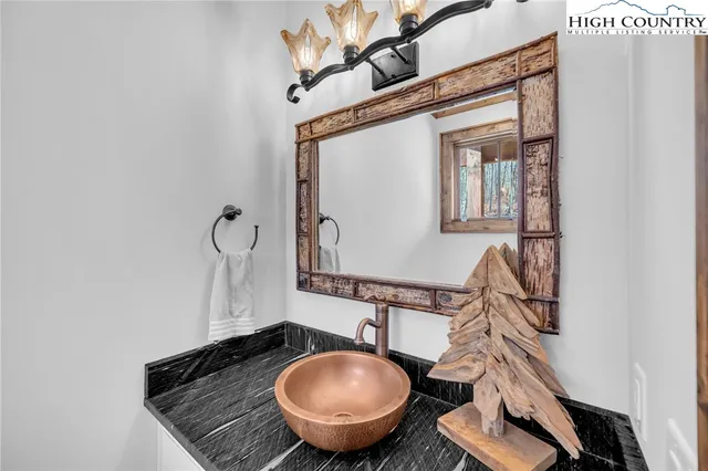 a living room with furniture fireplace and a large window