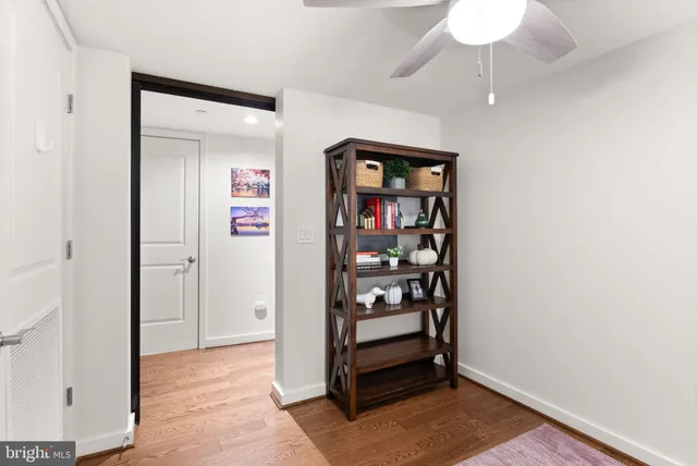 an empty room that has a painting on the wall