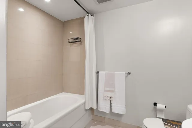 a bathroom with a bathtub and a toilet