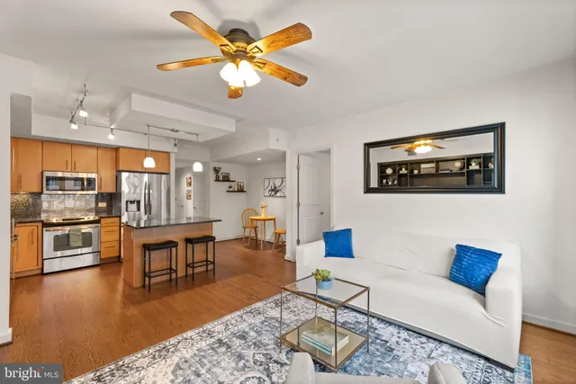 a living room with furniture and a kitchen view