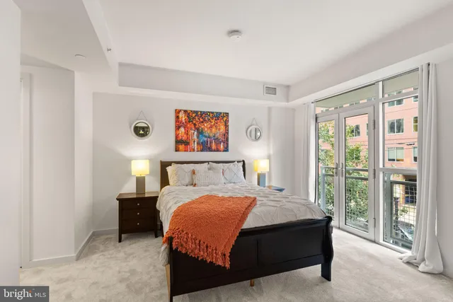 a bedroom with a bed and a large window