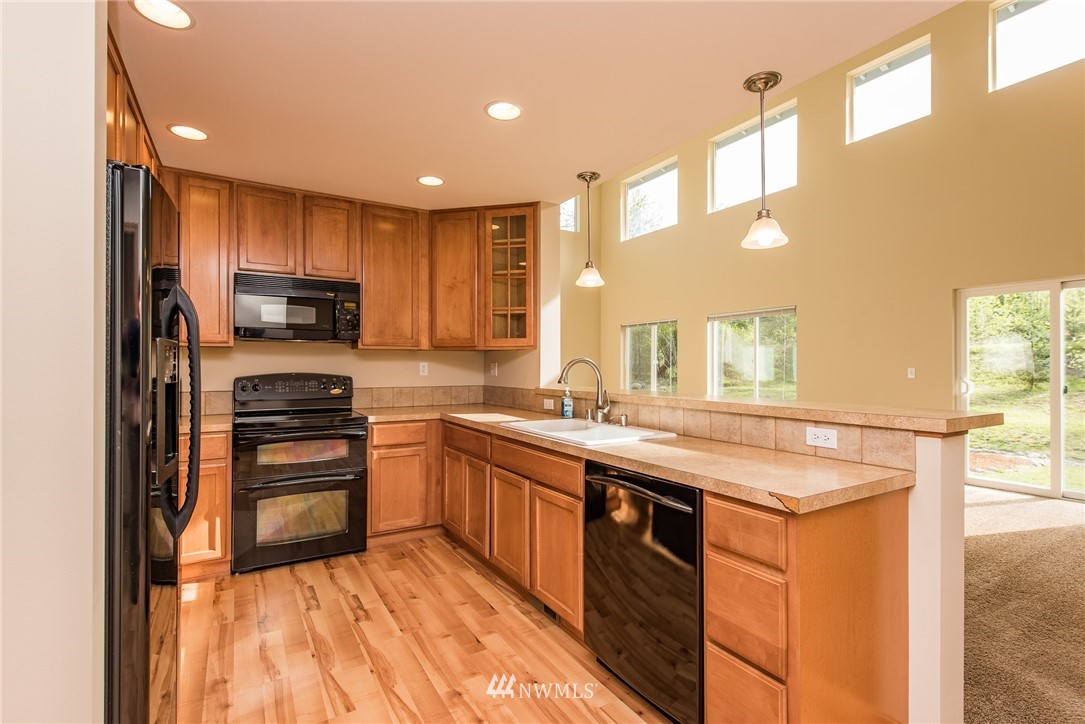 86 Hidden Valley Road Port Angeles, WA 98362 - Photo 15 of 23 a kitchen with stainless steel appliances granite countertop a stove top oven a sink and dishwasher