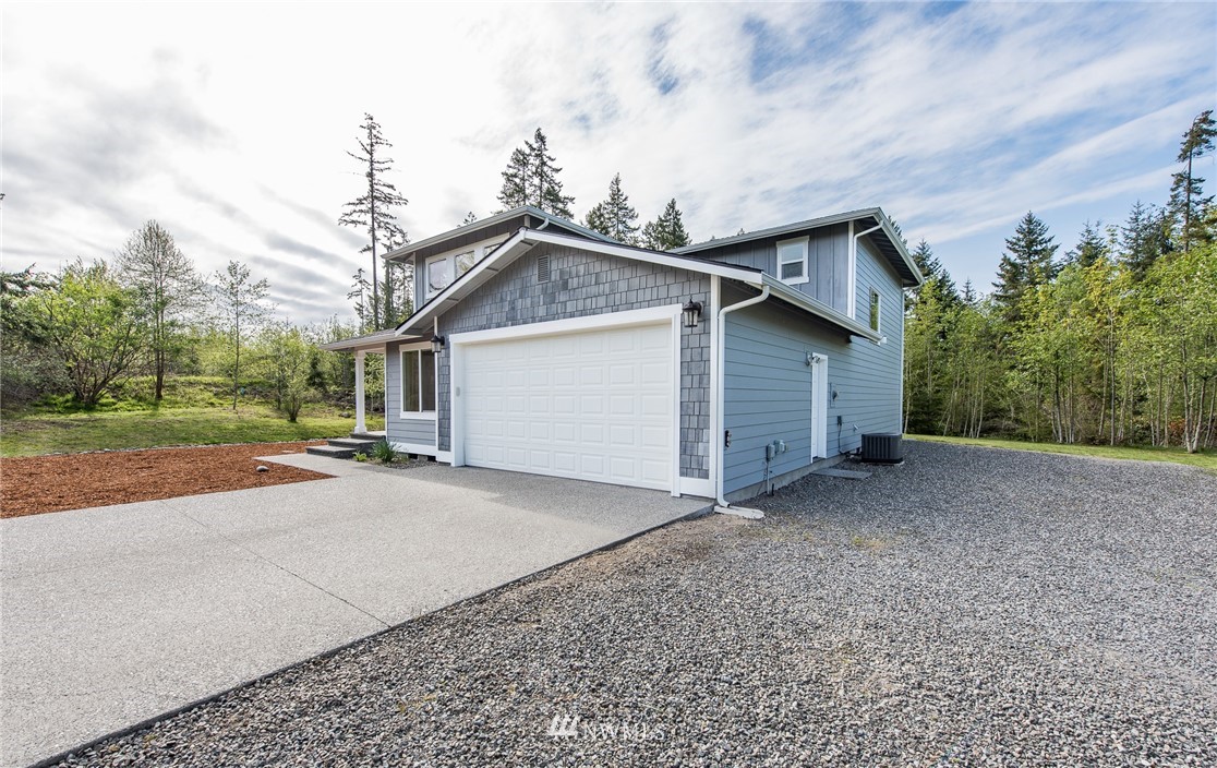 86 Hidden Valley Road Port Angeles, WA 98362 - Photo 3 of 23 a view of a house with a yard and garage