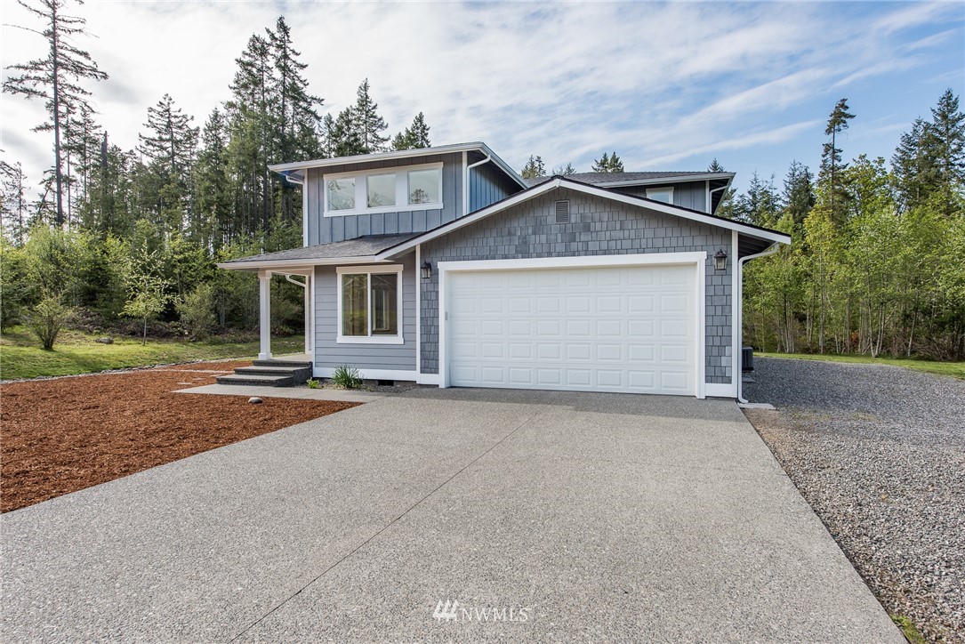 86 Hidden Valley Road Port Angeles, WA 98362 - Photo 4 of 23 a view of a house with a yard and garage