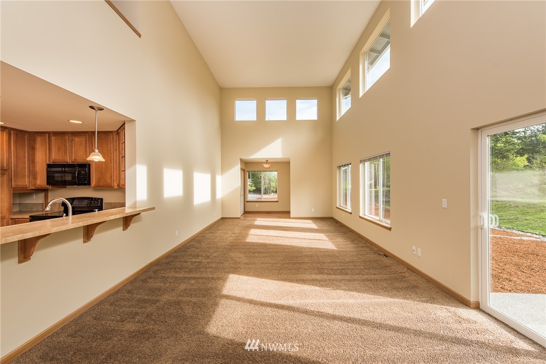 86 Hidden Valley Road Port Angeles, WA 98362 - Photo 6 of 23 a view of an entryway with wooden floor and a living room