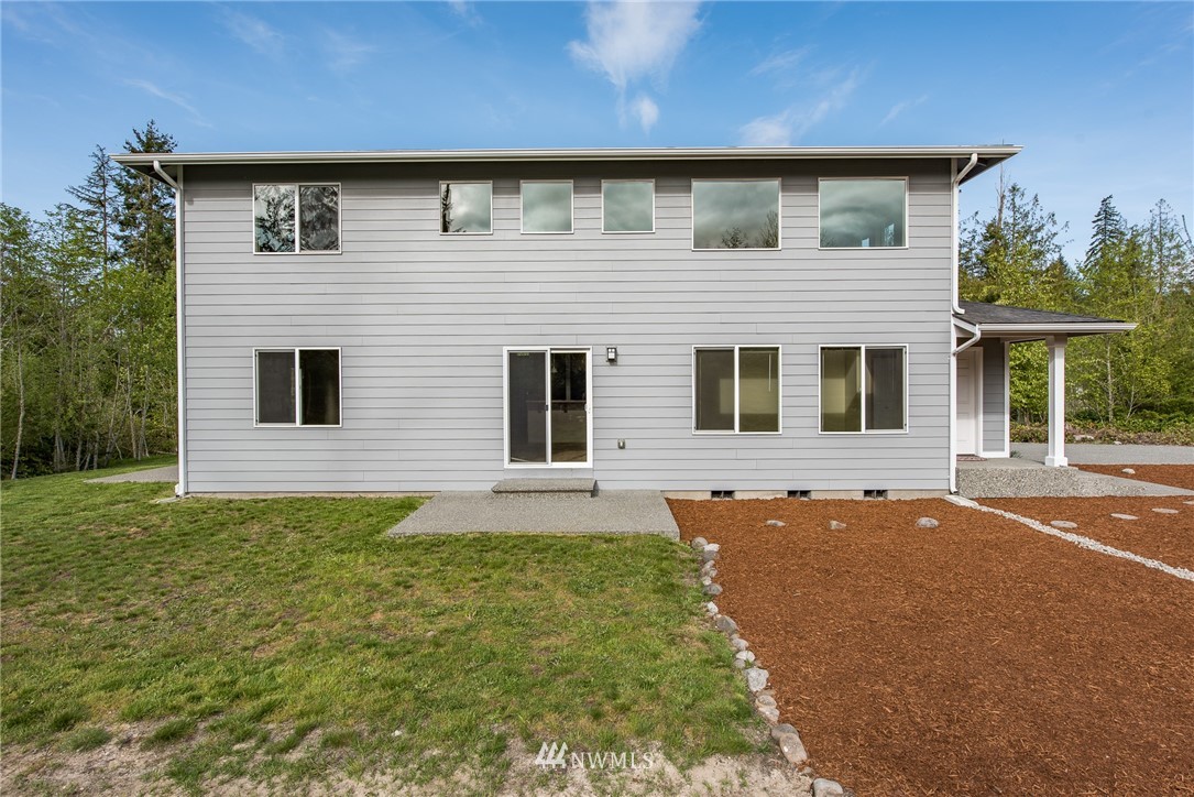 86 Hidden Valley Road Port Angeles, WA 98362 - Photo 8 of 23 a front view of a house with a garden