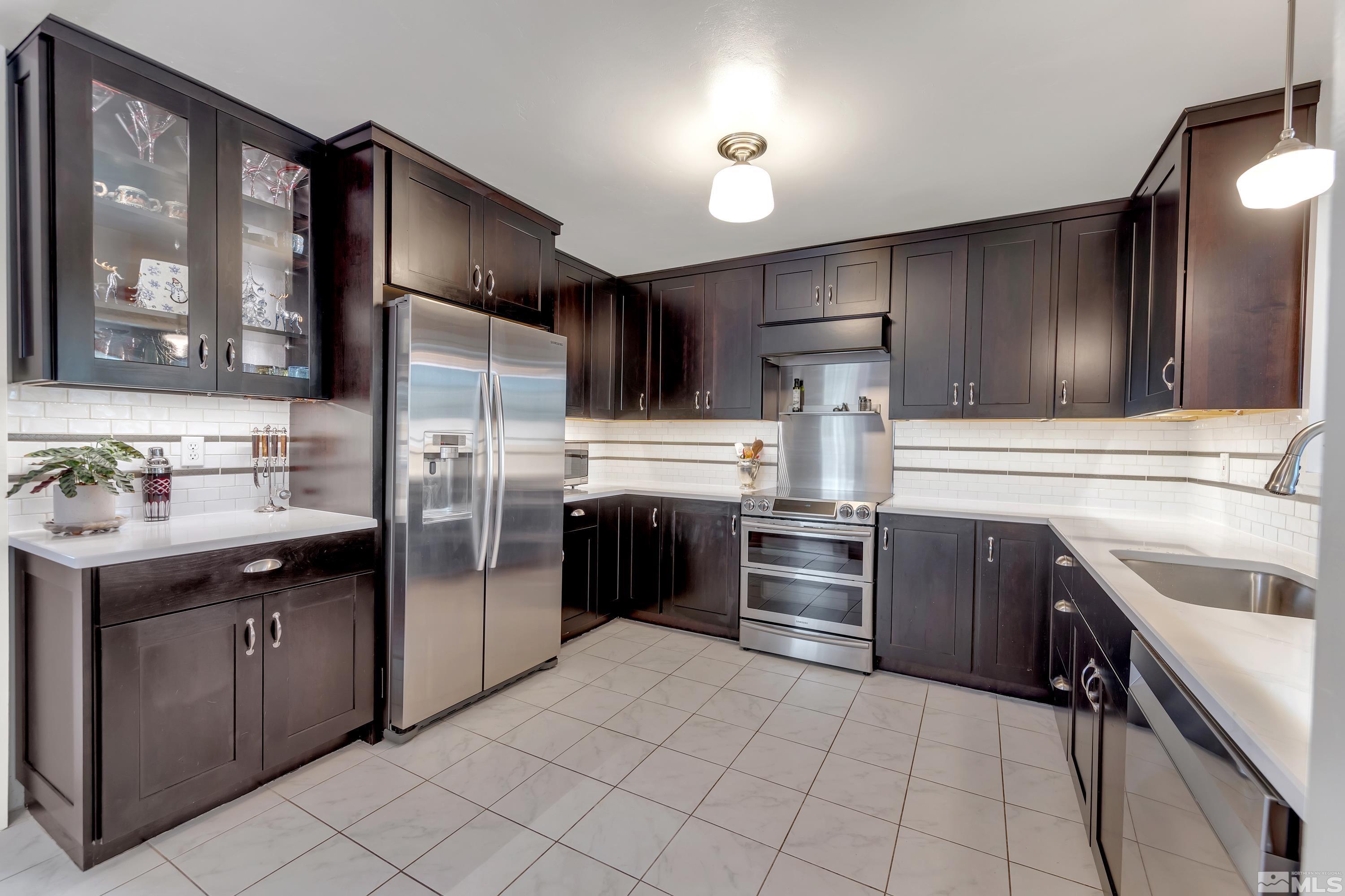 1575 Wesley Drive Reno, NV 89503 - Photo 11 of 40 a kitchen with stainless steel appliances granite countertop a refrigerator and a stove top oven