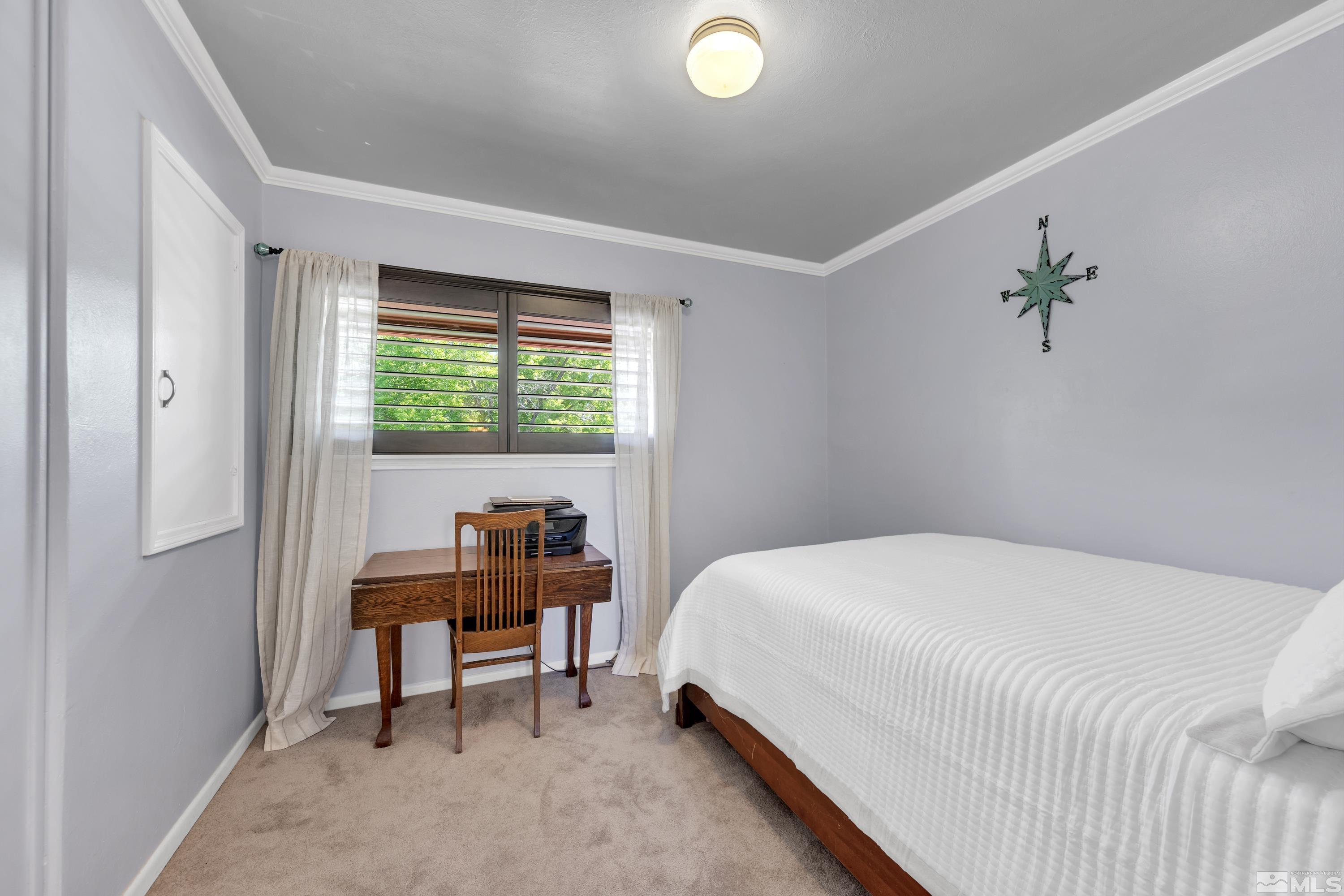1575 Wesley Drive Reno, NV 89503 - Photo 20 of 40 a bedroom with a bed and a window