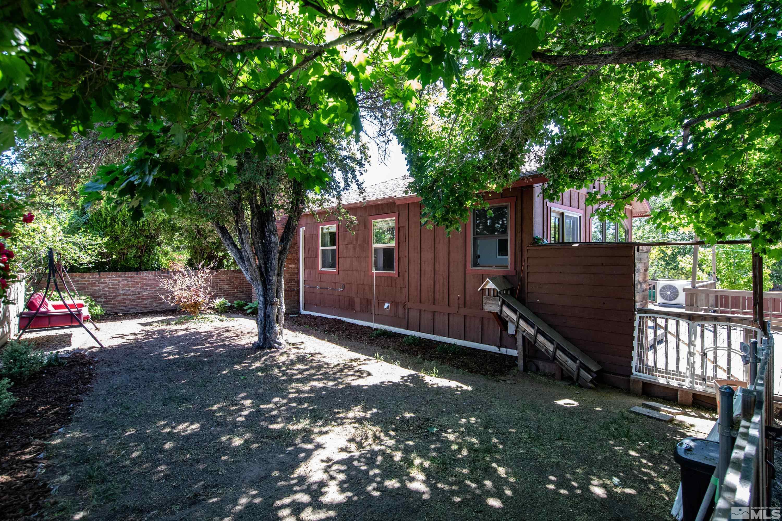 1575 Wesley Drive Reno, NV 89503 - Photo 36 of 40 a view of backyard with wooden fence and a large tree
