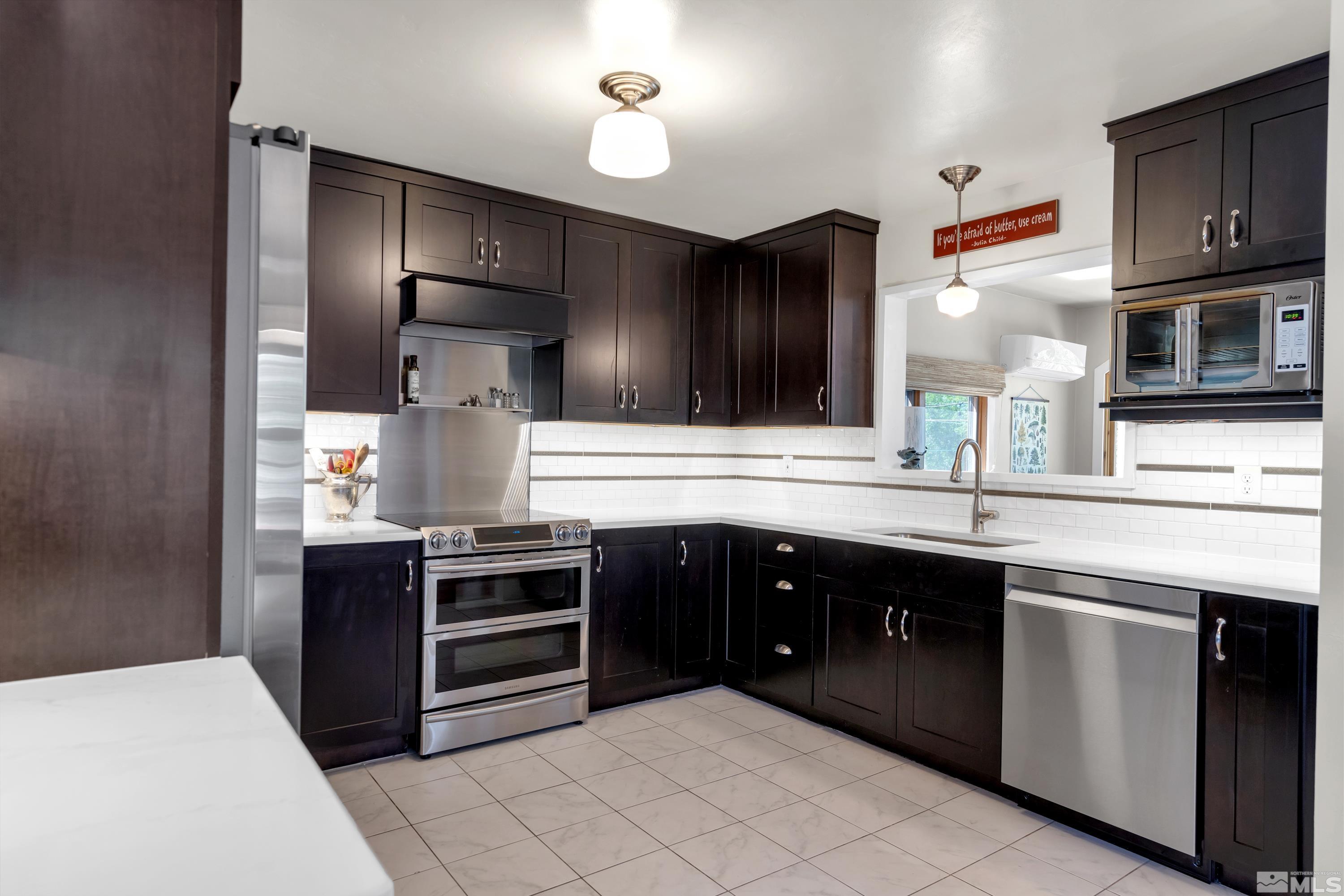 1575 Wesley Drive Reno, NV 89503 - Photo 10 of 40 a kitchen with stainless steel appliances a stove and more cabinets