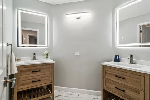 a bathroom with a sink a vanity and a mirror